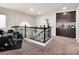 Second floor loft featuring carpet, a black metal railing and built-in cabinets, perfect for entertaining at 6465 Grande River Ct, Las Vegas, NV 89139