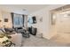 Comfortable living room with a sofa, side chair, modern decor, and plush carpeting at 6835 Orange Horizon St, North Las Vegas, NV 89086