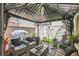 Cozy covered patio with wicker furniture, a fire pit, grill, and swing set, creating a perfect outdoor living space at 6835 Orange Horizon St, North Las Vegas, NV 89086