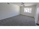 Spacious bedroom with plush carpet, a ceiling fan, and a window view at 6842 Greengrove Dr, Las Vegas, NV 89103