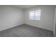 This bedroom features neutral carpet, light walls, and a window with modern blinds at 6842 Greengrove Dr, Las Vegas, NV 89103