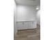 Hallway featuring white cabinets, light walls, and wood flooring at 6842 Greengrove Dr, Las Vegas, NV 89103