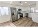 Well-lit kitchen featuring stainless steel appliances, white cabinetry, and modern countertops at 6842 Greengrove Dr, Las Vegas, NV 89103