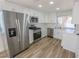 Bright kitchen with stainless steel appliances, white cabinets, and a functional layout at 6842 Greengrove Dr, Las Vegas, NV 89103