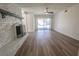 Inviting living room with hardwood floors, brick fireplace and access to the outdoor space at 6842 Greengrove Dr, Las Vegas, NV 89103