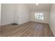 A bright living room with light wood flooring, a front window, and high ceilings at 6842 Greengrove Dr, Las Vegas, NV 89103
