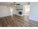 Open-concept living room featuring a white brick fireplace and light wood floors at 6842 Greengrove Dr, Las Vegas, NV 89103