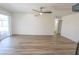 An airy living room with light wood flooring, a ceiling fan, and sliding door to patio at 6842 Greengrove Dr, Las Vegas, NV 89103