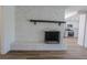 Living room view of white brick fireplace and a glimpse into the updated kitchen at 6842 Greengrove Dr, Las Vegas, NV 89103