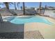 A clean and inviting backyard pool with a smooth concrete deck and desert-style landscaping at 6842 Greengrove Dr, Las Vegas, NV 89103