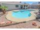 Inviting backyard pool featuring a unique design, surrounded by desert landscaping at 6842 Greengrove Dr, Las Vegas, NV 89103