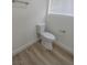 Toilet located in a clean bathroom with wood-look flooring at 6842 Greengrove Dr, Las Vegas, NV 89103