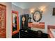 Bathroom with black tiled floor, black vanity, and an adjacent tub and shower at 7296 Mission Hills Dr, Las Vegas, NV 89113