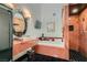 Bathroom featuring a tub, separate shower, black tiled floor, and marble accents at 7296 Mission Hills Dr, Las Vegas, NV 89113