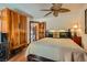 Comfortable bedroom with a ceiling fan and wooden cabinets and door at 7296 Mission Hills Dr, Las Vegas, NV 89113