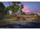 Charming single-story home featuring a red tile roof and mature landscaping at 7296 Mission Hills Dr, Las Vegas, NV 89113