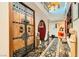 Grand foyer with a decorative rug, ornate wood door, and statue accents at 7296 Mission Hills Dr, Las Vegas, NV 89113