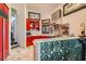 The kitchen features red cabinets, a stainless steel Wolf range, and a unique textured breakfast bar at 7296 Mission Hills Dr, Las Vegas, NV 89113