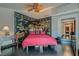Bedroom with dark hardwood floors, red accents, and unique artwork on the walls at 7296 Mission Hills Dr, Las Vegas, NV 89113