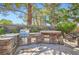 The outdoor kitchen features a stone counter and grill at 7296 Mission Hills Dr, Las Vegas, NV 89113