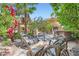 Outdoor entertainment area featuring a grill, patio seating, and lush landscaping at 7296 Mission Hills Dr, Las Vegas, NV 89113