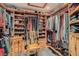Spacious walk-in closet with custom shelving and a wooden chair at 7296 Mission Hills Dr, Las Vegas, NV 89113