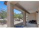 Spacious covered patio featuring textured columns and outdoor seating area at 7448 Lintwhite St, North Las Vegas, NV 89084