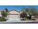 Traditional-style home with desert landscaping, a two-car garage, and neutral stucco at 7448 Lintwhite St, North Las Vegas, NV 89084