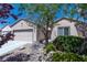 Charming single-story home featuring low-maintenance desert landscaping, neutral stucco, and an attached two-car garage at 7448 Lintwhite St, North Las Vegas, NV 89084