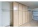 View of a garage interior showcasing built-in storage cabinets and a partially opened garage door at 7448 Lintwhite St, North Las Vegas, NV 89084