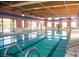 Indoor pool with swimming lanes, sauna, and lounge chairs at 7448 Lintwhite St, North Las Vegas, NV 89084