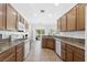 Open concept kitchen with granite countertops, tile flooring, wood cabinets, and stainless steel appliances at 7448 Lintwhite St, North Las Vegas, NV 89084