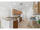 Well-lit kitchen featuring granite countertops, wood cabinetry, and stainless steel appliances at 7448 Lintwhite St, North Las Vegas, NV 89084