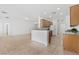 Open concept kitchen with tile flooring, granite counters, wood cabinets, and stainless steel appliances at 7448 Lintwhite St, North Las Vegas, NV 89084