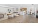 Bright open-concept living room and kitchen with breakfast bar and dining area at 7448 Lintwhite St, North Las Vegas, NV 89084