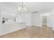 Bright living space with tile flooring, a modern chandelier, and an open layout leading to a bathroom and living room at 7448 Lintwhite St, North Las Vegas, NV 89084