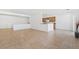 Open-concept living space with tile floors flowing into a kitchen area with a half-wall divider at 7448 Lintwhite St, North Las Vegas, NV 89084