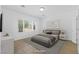 Staged main bedroom with modern furnishings, large windows, and neutral tile at 7448 Lintwhite St, North Las Vegas, NV 89084