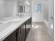 Bathroom with double sinks, modern dark cabinets, and a separate shower and tub at 7791 Misty Oaks Ave, Las Vegas, NV 89113
