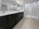 Bathroom with double sink vanity, dark cabinets, and a glass-enclosed shower at 7791 Misty Oaks Ave, Las Vegas, NV 89113