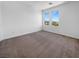 Bright bedroom featuring two windows and carpeted floors at 7791 Misty Oaks Ave, Las Vegas, NV 89113