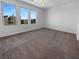 Bright bedroom with neutral carpet and three windows with neighborhood views at 7791 Misty Oaks Ave, Las Vegas, NV 89113