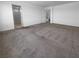Large bedroom with neutral carpet, multiple entryways, and bright lighting at 7791 Misty Oaks Ave, Las Vegas, NV 89113