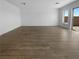 Open-concept living room showcasing wood-look flooring and backyard access at 7791 Misty Oaks Ave, Las Vegas, NV 89113
