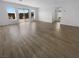 Open-concept living room showcasing wood-look flooring and backyard access at 7791 Misty Oaks Ave, Las Vegas, NV 89113