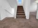 Carpeted stairway with white walls and wooden handrails at 7791 Misty Oaks Ave, Las Vegas, NV 89113