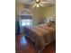 Comfortable bedroom with light-colored walls, window, and wooden floors at 7950 W Flamingo Rd # 2074, Las Vegas, NV 89147