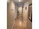 Hallway leading to closet; decorated with decorative mirror and a framed wine-themed art at 7950 W Flamingo Rd # 2074, Las Vegas, NV 89147