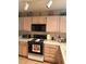 Functional kitchen featuring light wood cabinetry, white countertops, and essential appliances at 7950 W Flamingo Rd # 2074, Las Vegas, NV 89147