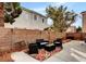 Relaxing backyard with patio furniture and a brick wall, creating a private outdoor living space at 971 Whispering Grove Ave, Las Vegas, NV 89123